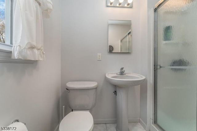 full bathroom with toilet, a shower stall, baseboards, and tile patterned flooring