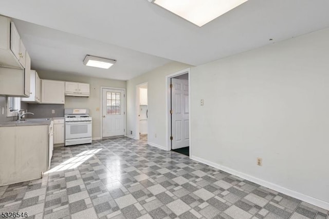 kitchen with sink, gas range gas stove, and white cabinets