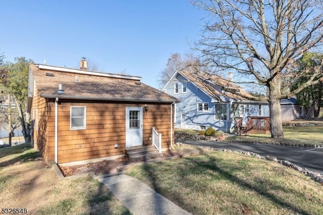 rear view of house with a lawn