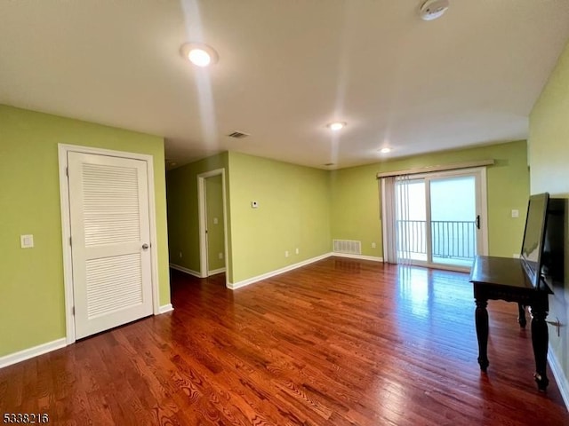 unfurnished living room featuring dark wood-type flooring