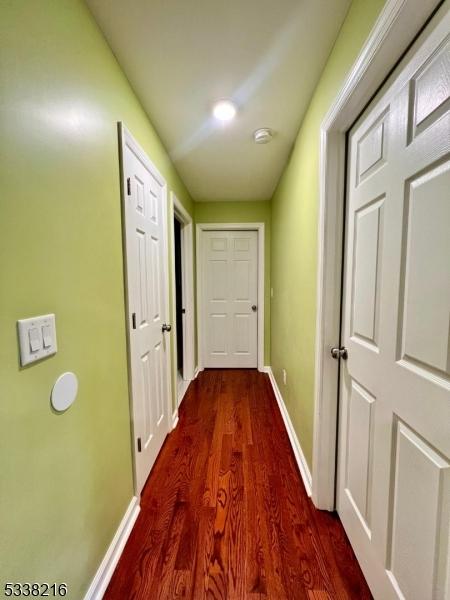 corridor featuring wood-type flooring