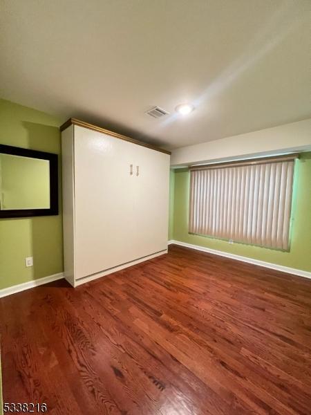 empty room with wood-type flooring