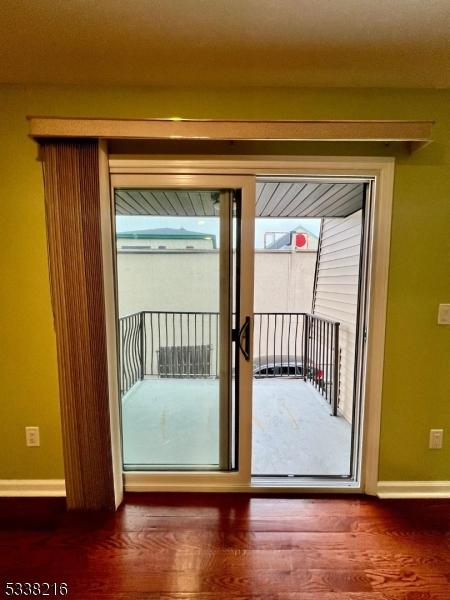 doorway with hardwood / wood-style floors