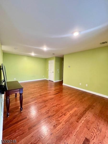 empty room with wood-type flooring