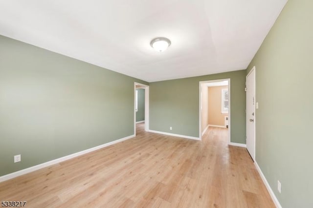 empty room with light hardwood / wood-style flooring