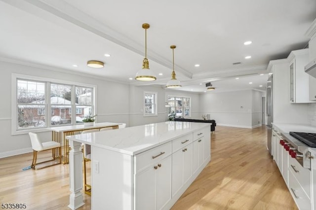 kitchen featuring pendant lighting, light hardwood / wood-style flooring, white cabinets, and a kitchen island