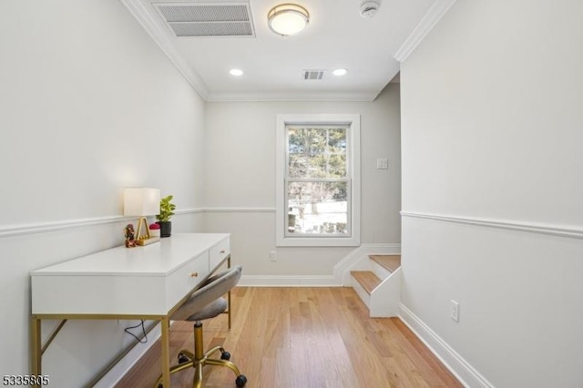 home office featuring crown molding and light hardwood / wood-style flooring