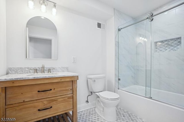 full bathroom featuring shower / bath combination with glass door, vanity, toilet, and tile patterned flooring