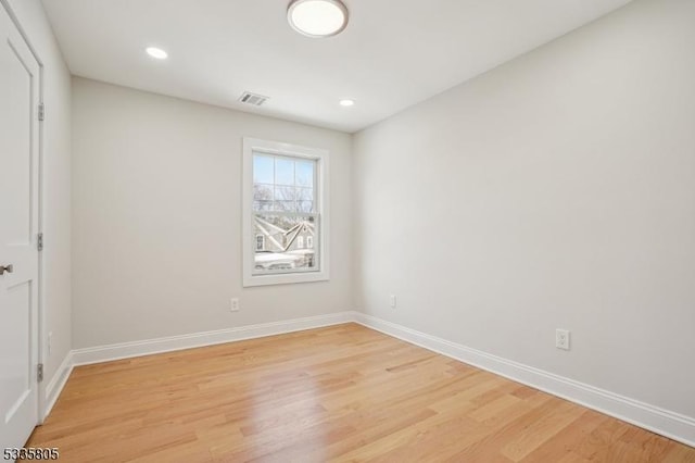 spare room featuring light hardwood / wood-style flooring