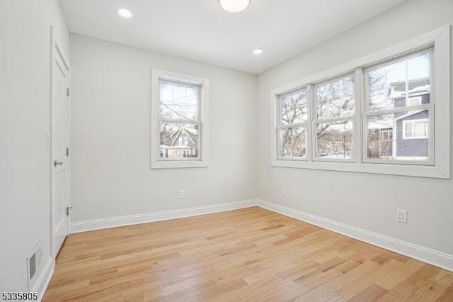 unfurnished room with a wealth of natural light and light wood-type flooring