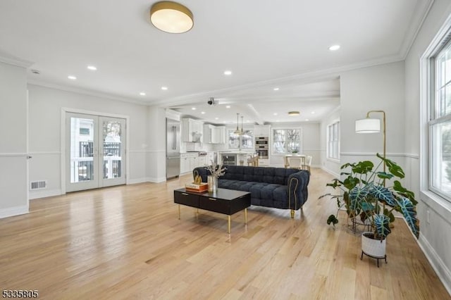 living room featuring crown molding and light hardwood / wood-style floors