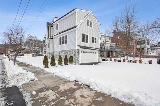 view of snow covered exterior featuring a garage