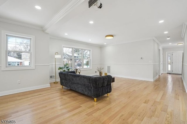 living room with ornamental molding and light hardwood / wood-style floors