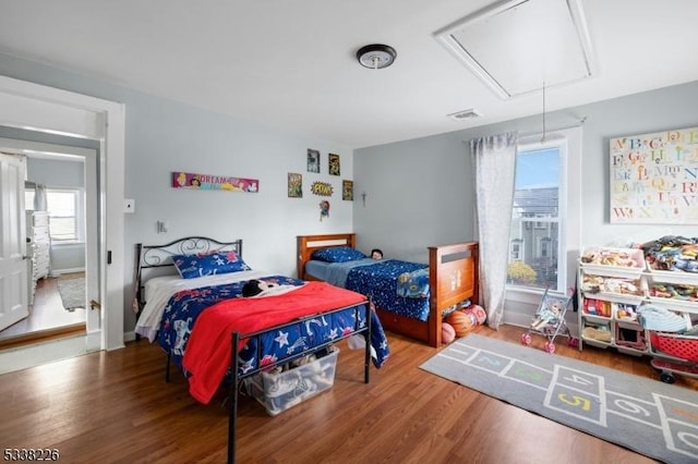 147 E Main St, Rockaway Boro, NJ 07866 - bedroom featuring visible vents, wood finished floors, and attic access