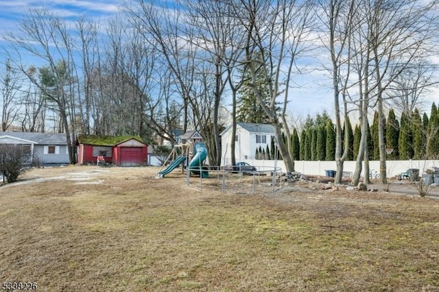 147 E Main St, Rockaway Boro, NJ 07866 - view of yard featuring a garage, a playground, fence, and driveway