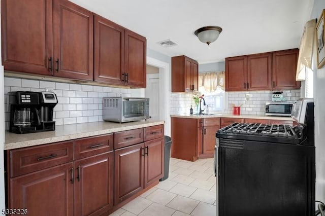 147 E Main St, Rockaway Boro, NJ 07866 - kitchen with light countertops, visible vents, stainless steel microwave, backsplash, and gas stove
