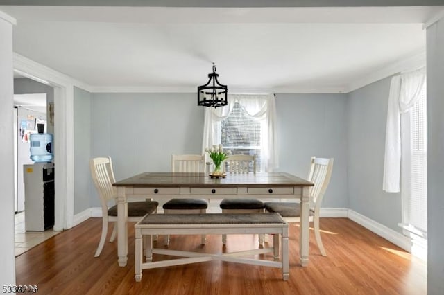 147 E Main St, Rockaway Boro, NJ 07866 - dining room with ornamental molding, light wood-style flooring, baseboards, and an inviting chandelier