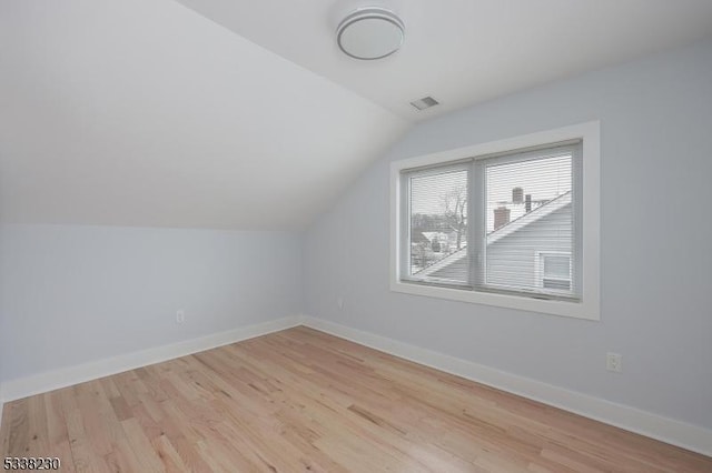 bonus room featuring vaulted ceiling and light hardwood / wood-style floors