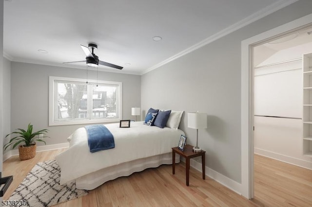 bedroom with crown molding, ceiling fan, and light wood-type flooring