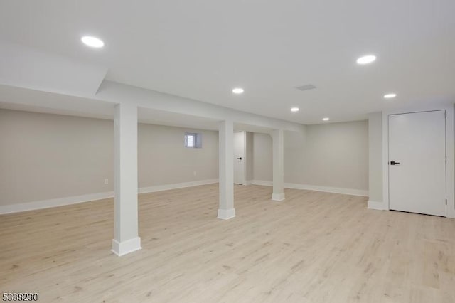 basement with light hardwood / wood-style floors