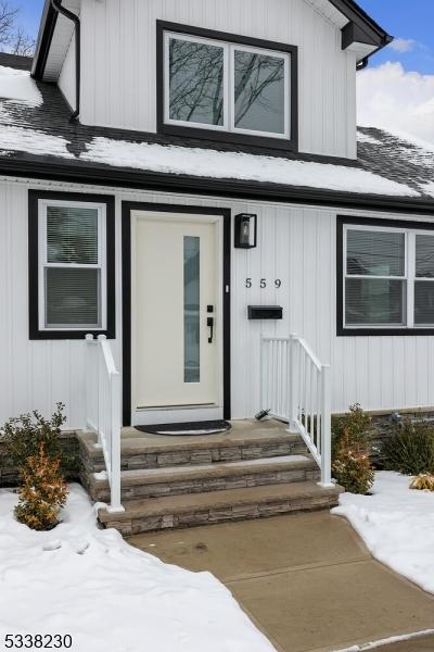 view of snow covered property entrance