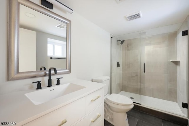 bathroom with vanity, toilet, an enclosed shower, and tile patterned flooring