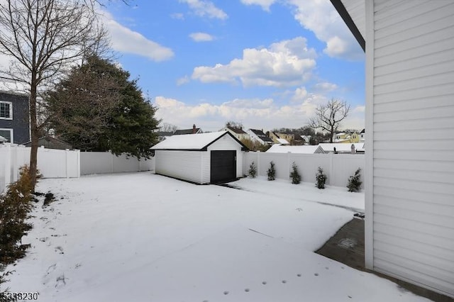 yard covered in snow featuring an outdoor structure