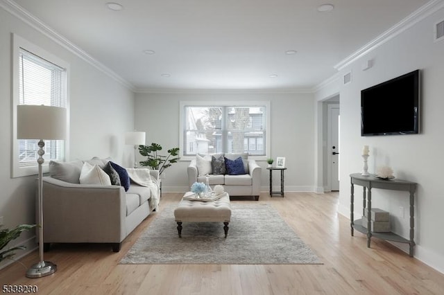 living room featuring ornamental molding and light hardwood / wood-style floors