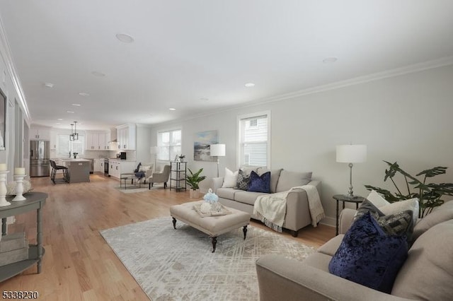 living room with crown molding and light wood-type flooring