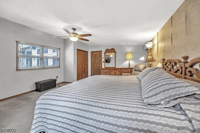 carpeted bedroom featuring ceiling fan and a textured ceiling