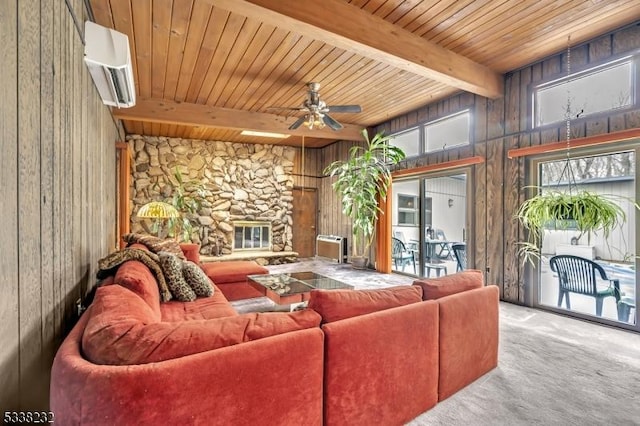 living room with wood ceiling, beam ceiling, a wall mounted AC, carpet floors, and a stone fireplace