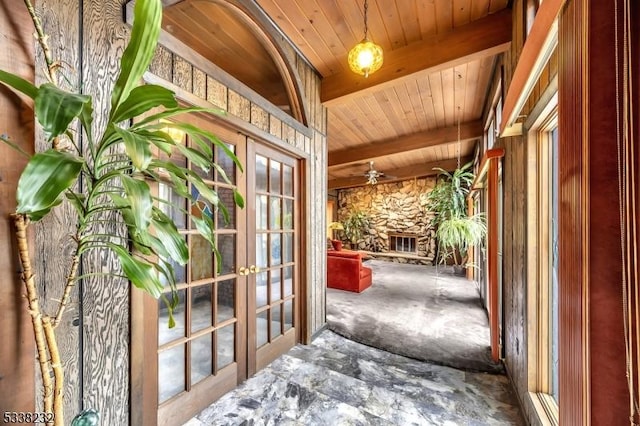 doorway with french doors, wood ceiling, and beam ceiling