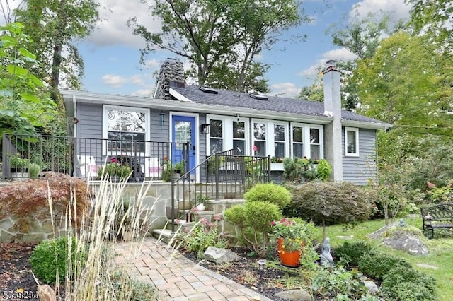 ranch-style house featuring a chimney