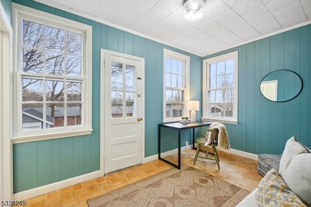 home office featuring crown molding and baseboards