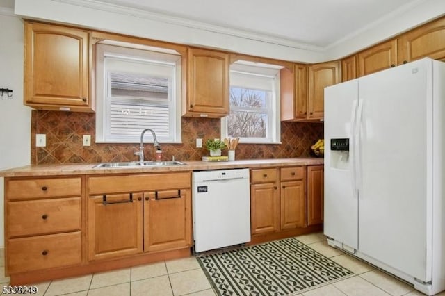 kitchen with tasteful backsplash, ornamental molding, white appliances, and a sink