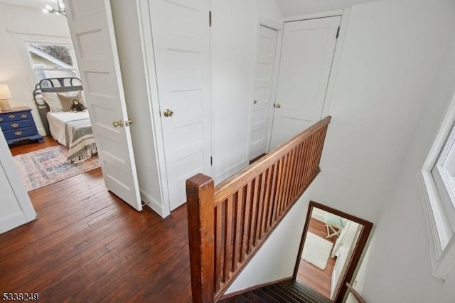 interior space featuring an upstairs landing and dark wood-type flooring