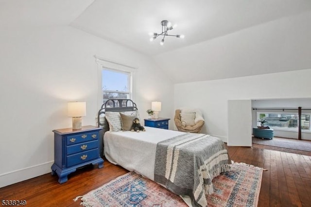 bedroom featuring vaulted ceiling, baseboards, dark wood-type flooring, and a chandelier