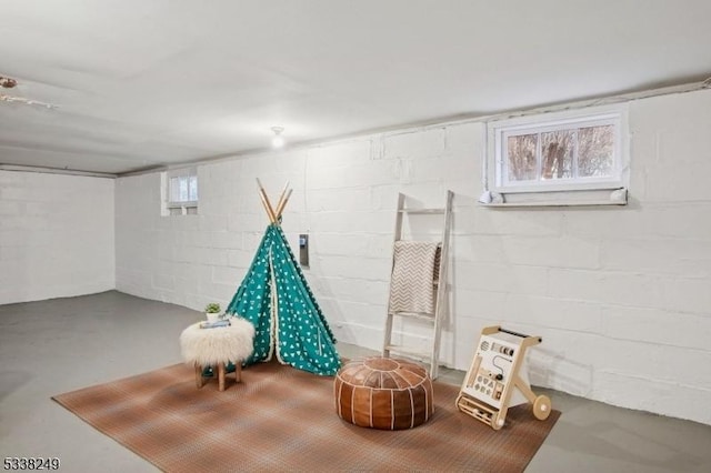 playroom featuring finished concrete floors