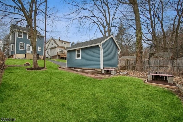 exterior space featuring an outdoor structure and fence