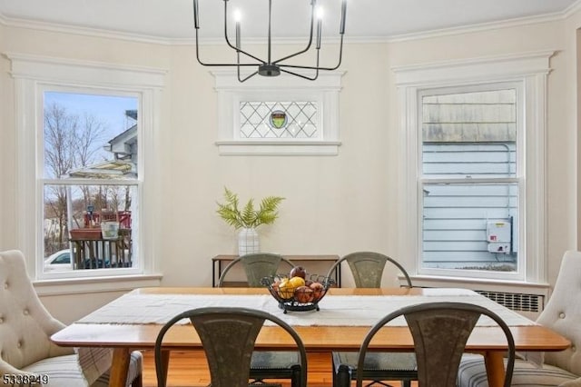 dining space featuring a chandelier and ornamental molding