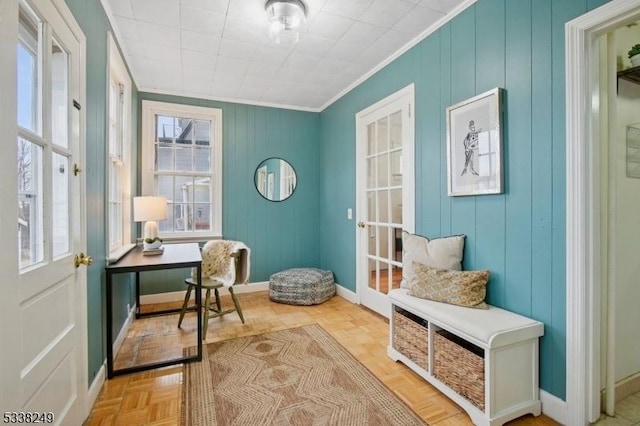 home office featuring a wealth of natural light, crown molding, and baseboards