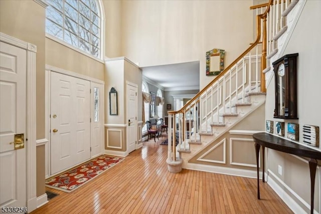 entryway with a high ceiling, a wealth of natural light, and a decorative wall