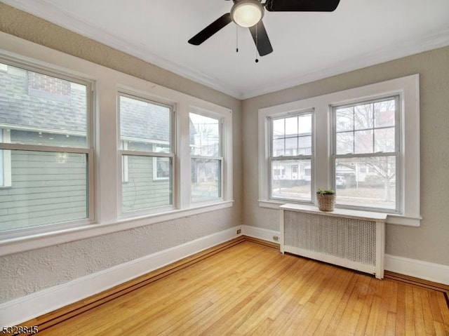 unfurnished sunroom with radiator