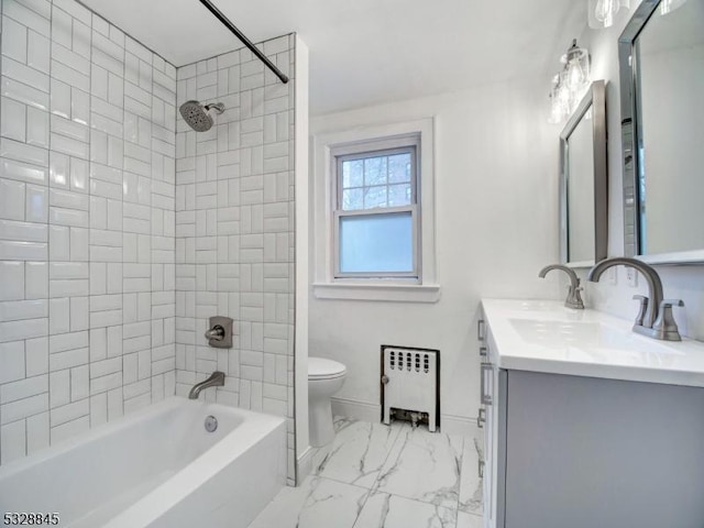 full bathroom featuring tiled shower / bath, radiator heating unit, vanity, and toilet