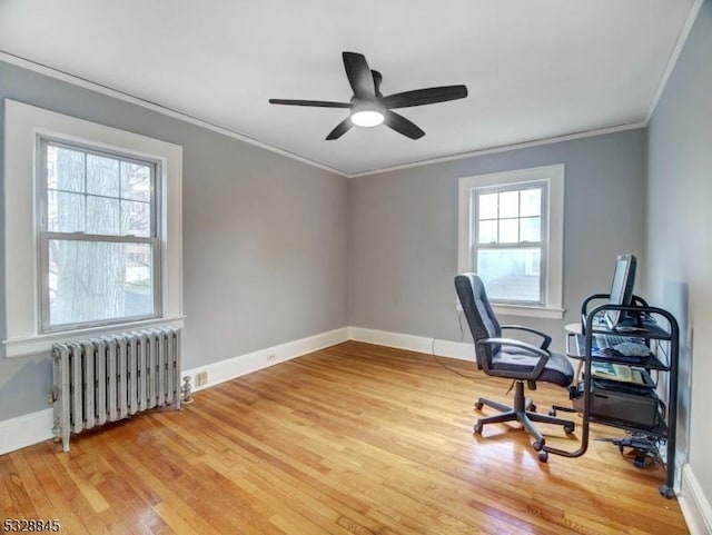 office featuring ornamental molding, radiator, hardwood / wood-style floors, and ceiling fan