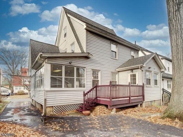 back of house featuring a deck