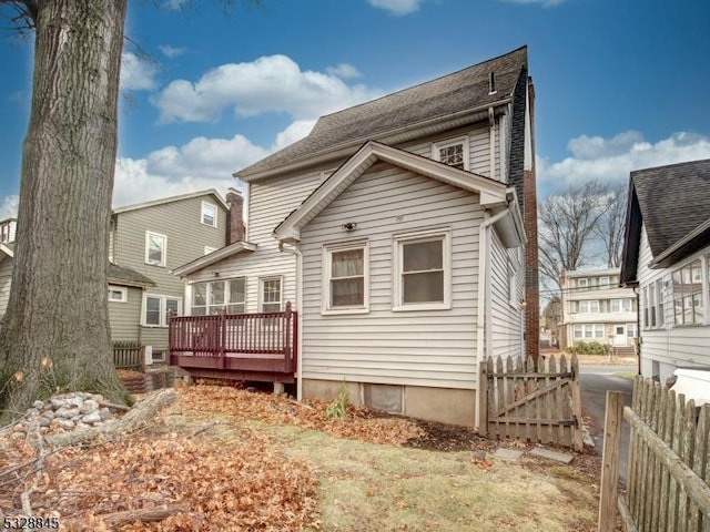 back of property with a wooden deck