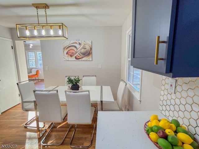 dining space with wood finished floors