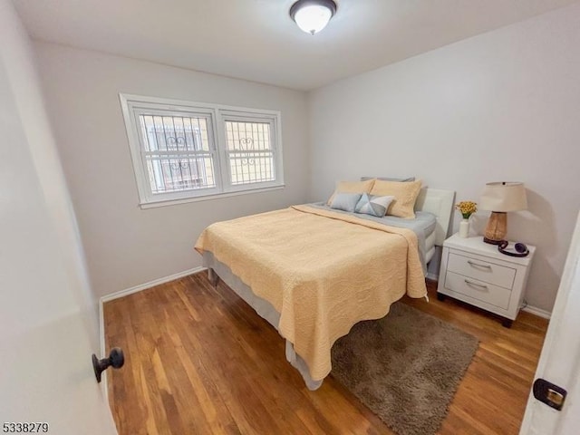 bedroom featuring light wood-style flooring and baseboards