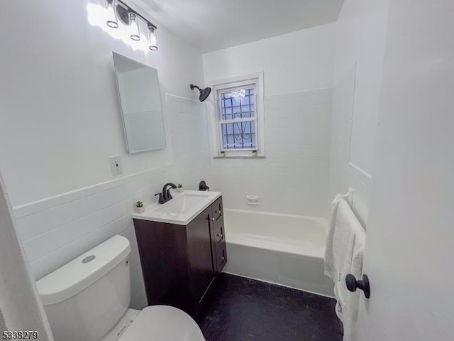 bathroom with washtub / shower combination, a wainscoted wall, toilet, vanity, and tile walls